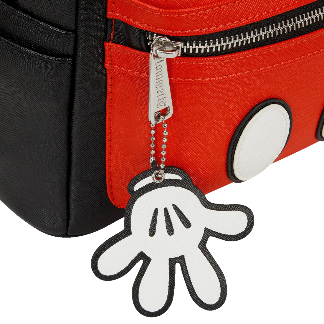 Keychain shaped like a Mickey hand attached to a red bag.