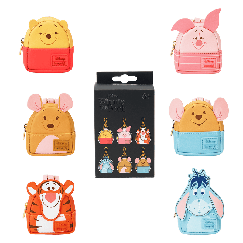 Collection of Winnie the Pooh themed loungefly bag charms on a white background.