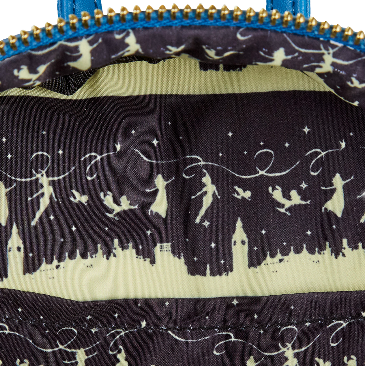 Close-up of a Peter Pan Loungefly backpack interior lining with Peter Pan, Wendy and the kids silhouettes on a dark background
