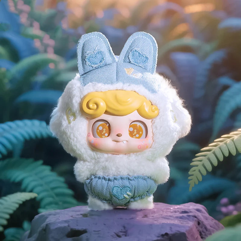 Cute Q Kid Dream bunny plush toy with their outfit standing on a rock with a natural background