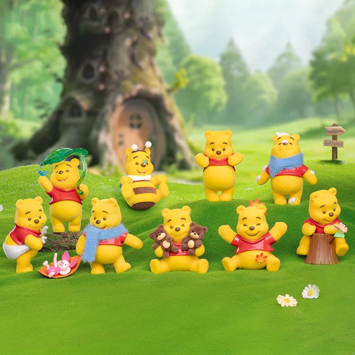 Set of Winnie the Pooh Happy Time Series figurines in a forest setting with trees and grass.