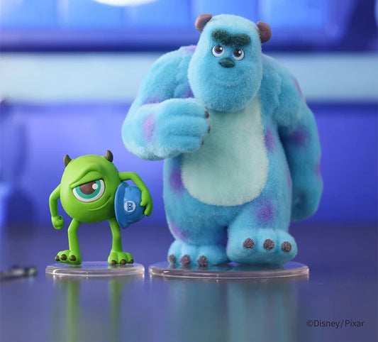 Mike & Sully from Monster Inc, on a reflective surface with a blurred background.