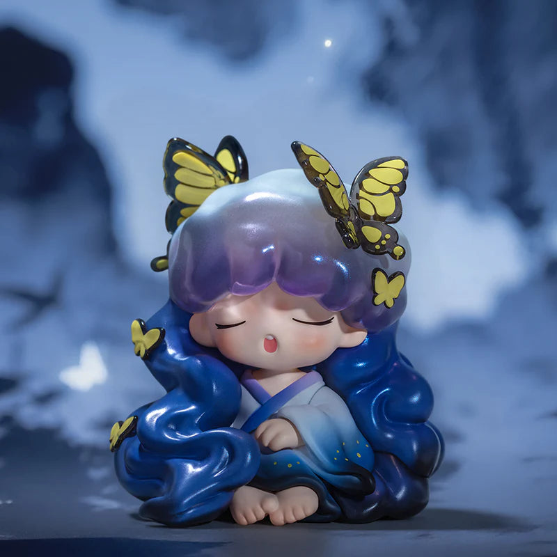 Yumo figurine of a child with butterfly wings on a blurred background