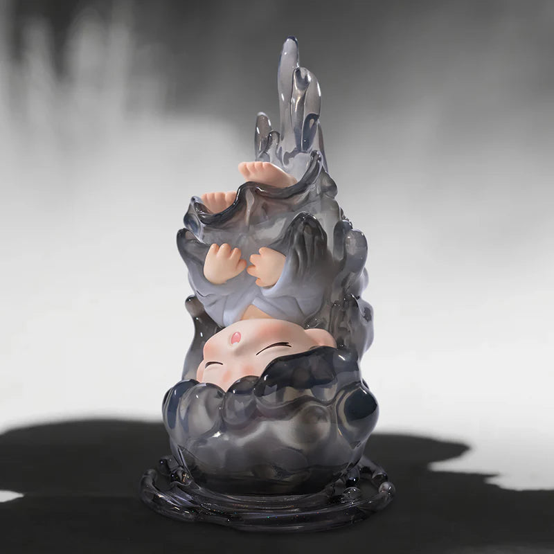 Yumo decorative figurine with a stylized face and outstretched hand on a dark background