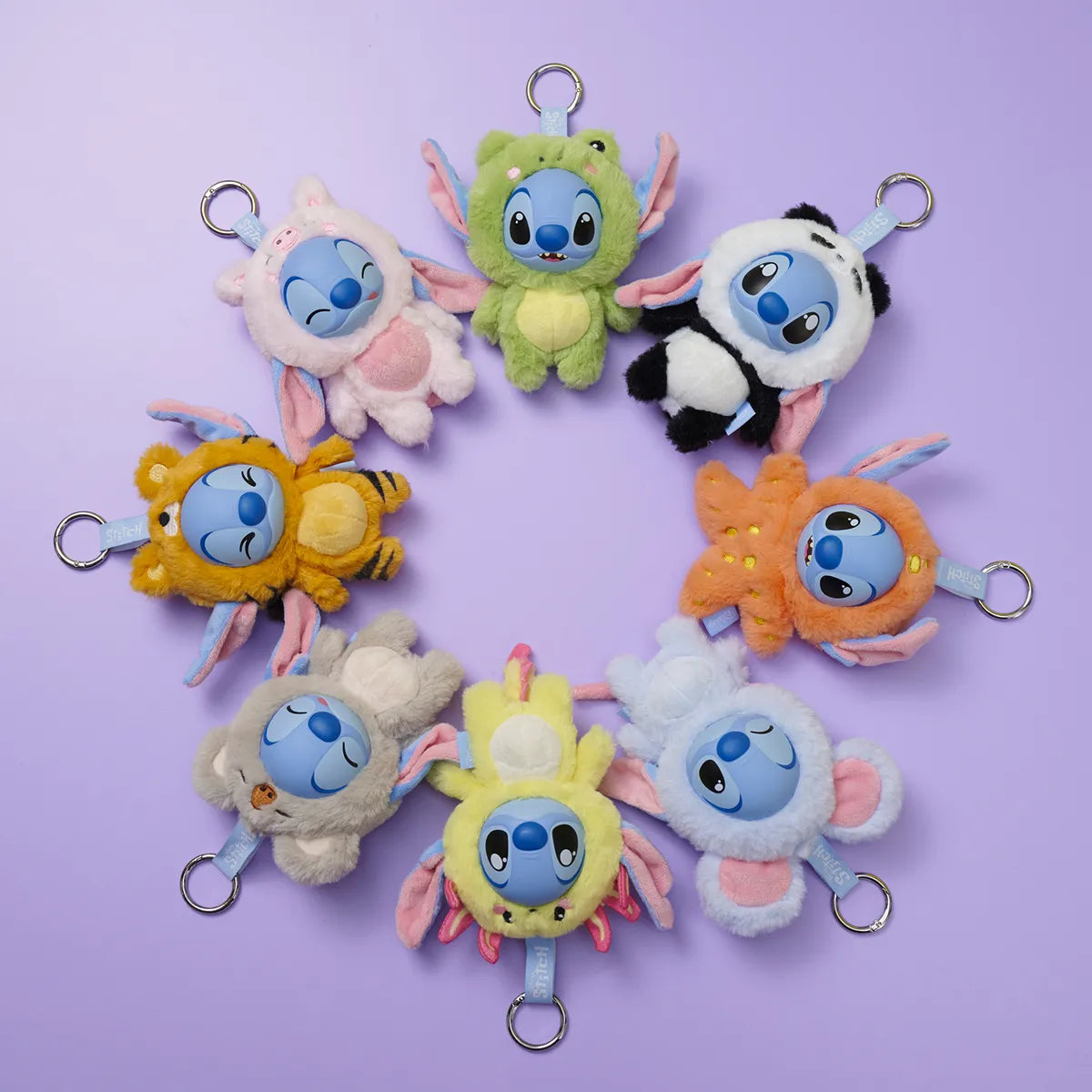 Set of Disney Stitch Yuyus keychains on a purple background