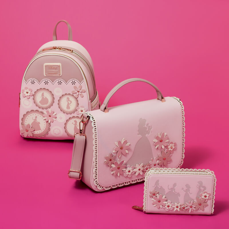 Set of pink Disney Princesses Loungefly bags with decorative patterns on a pink background