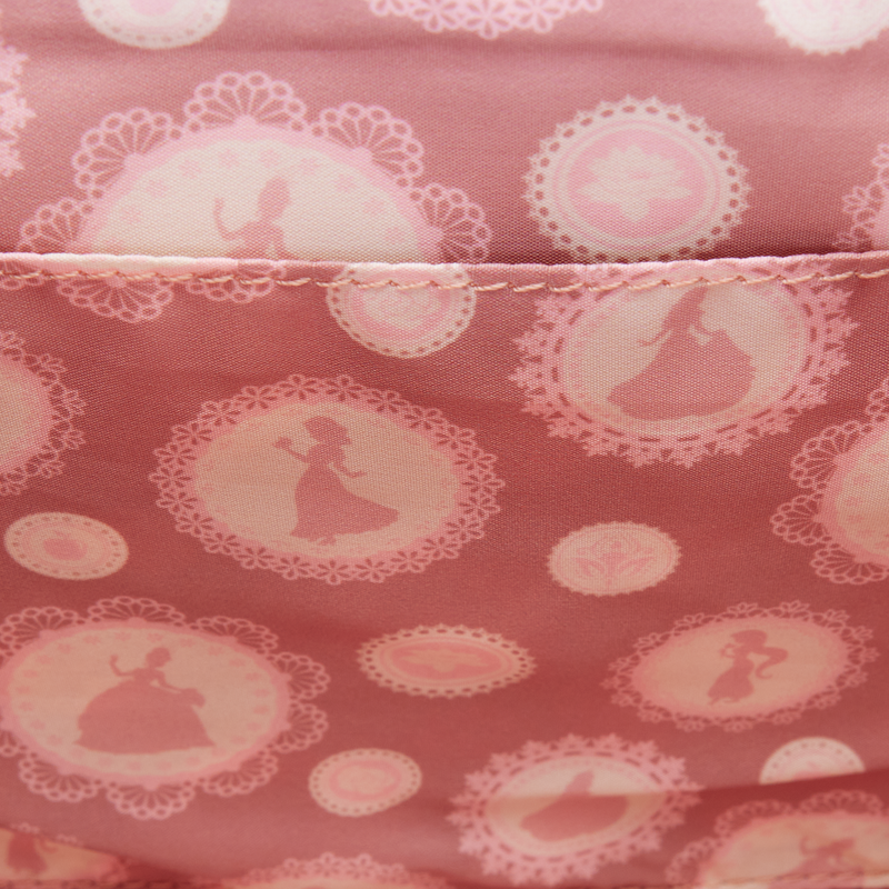 Disney princesses Loungefly interior fabric lining with circular patterns and princesses like snow white, cinderella, sleeping beauty, jasmin and Tiana silhouettes on a pink background