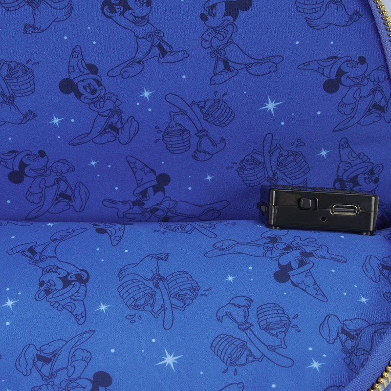 Blue fabric lining of sorcerer Mickey loungefly backpack with black sorcerer mickey patterns and a small black device on top to light up the bag