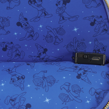 Blue fabric lining of sorcerer Mickey loungefly backpack with black sorcerer mickey patterns and a small black device on top to light up the bag