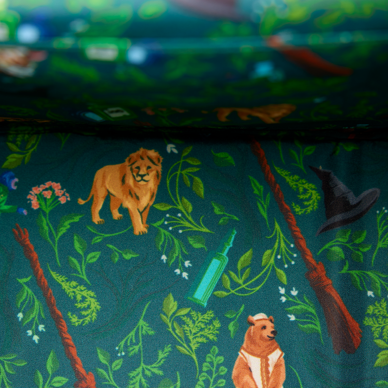 Wicked interior lining with jungle-themed design featuring animals and plants from Oz on a dark green background.