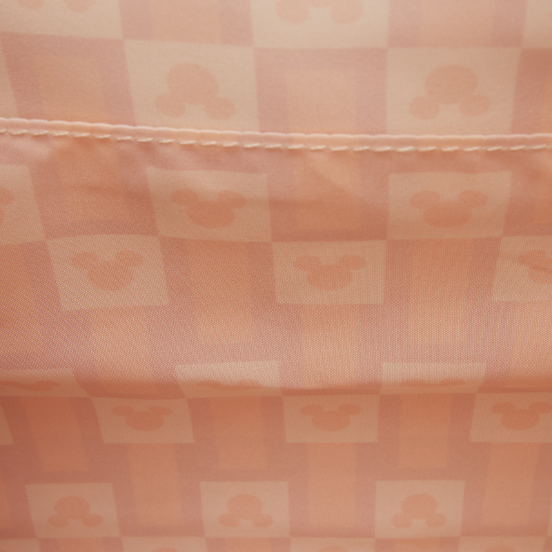 Checkered fabric with a pattern of squares in shades of pink and peach.