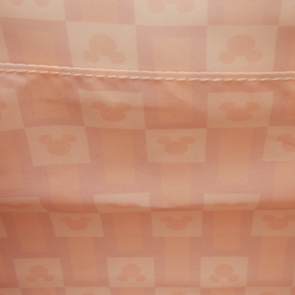 Checkered fabric with a pattern of squares in shades of pink and peach.