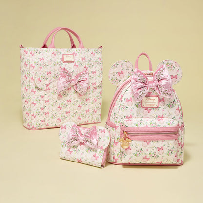 Set of floral Minnie Mouse Loungefly bags with pink bows on a beige background