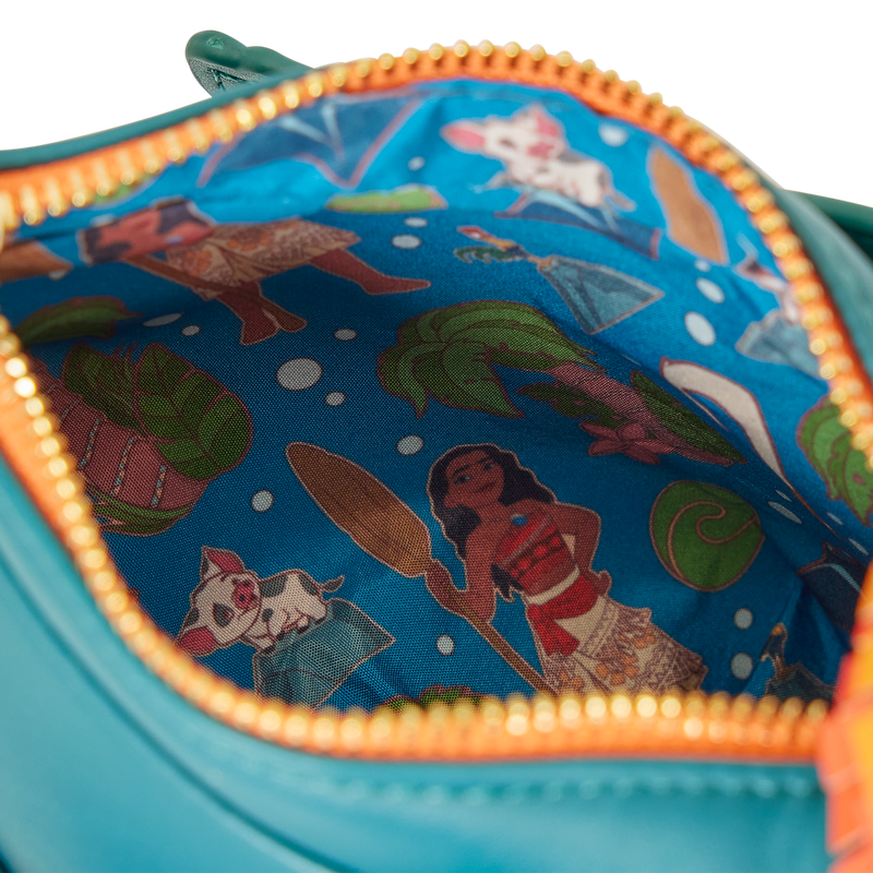 Close-up of a Hei Hei crossbody pouch with Moana pattern, featuring golden zipper.