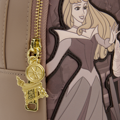 Gold spinning wheel charm attached to a bag with an illustration of a princess character.