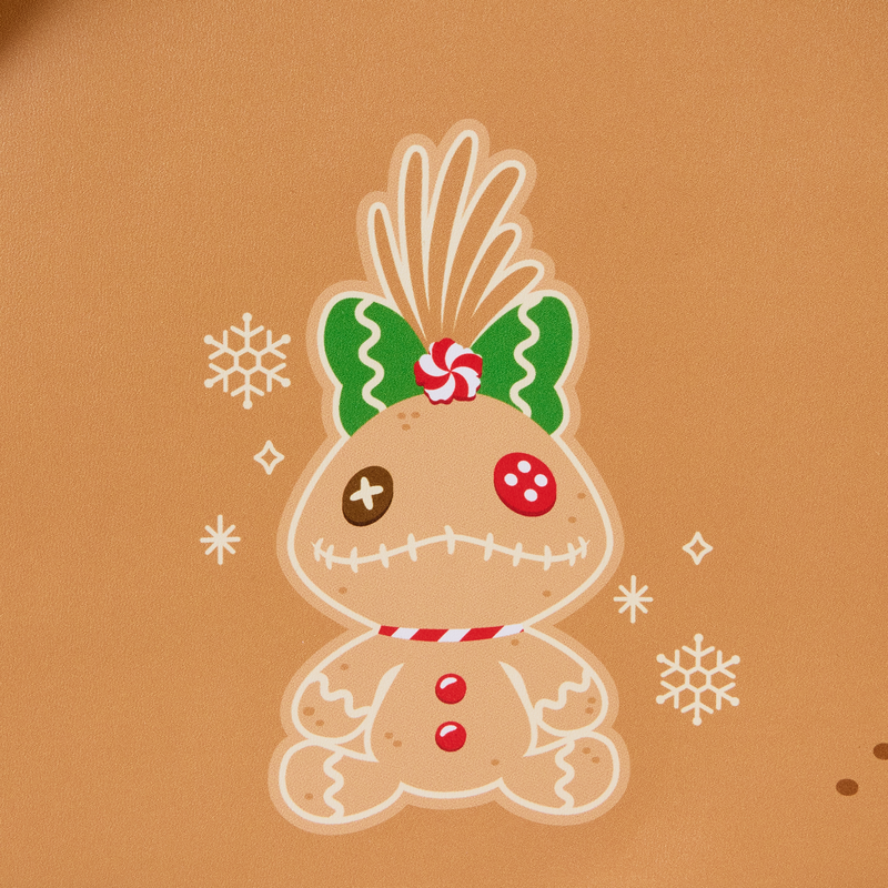 Gingerbread scrumpy with a bow and candy on a brown background