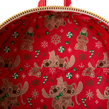 Close-up of fabric lining of Gingerbread stitch Loungefly backpack with a red fabric with Christmas-themed designs including gingerbread Stitch, Angel & Scrumpy, snowflakes, and candy canes