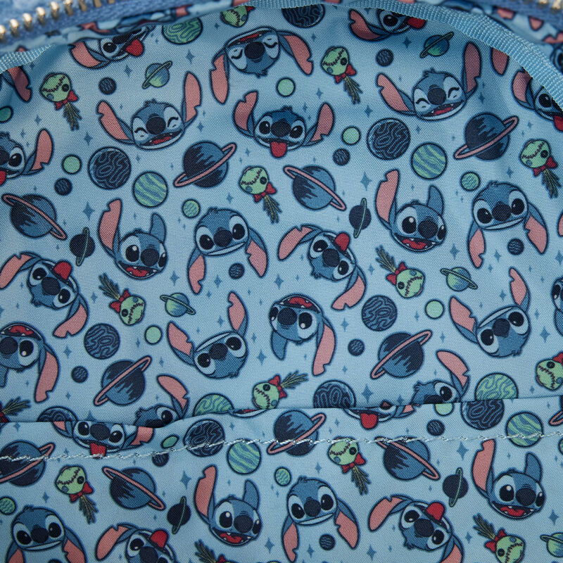 Patterned fabric lining of Stitch Sherpa backpack with Stitch and planets on a blue background