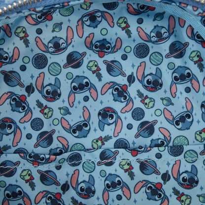 Patterned fabric lining of Stitch Sherpa backpack with Stitch and planets on a blue background