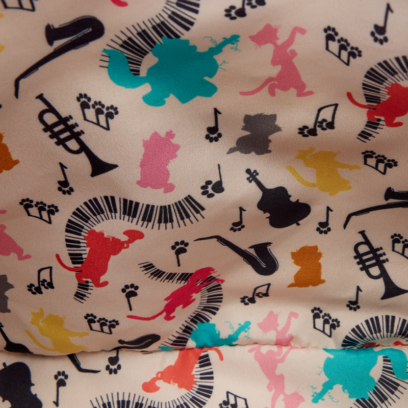 Colorful pattern of musical instruments and animals on a fabric background