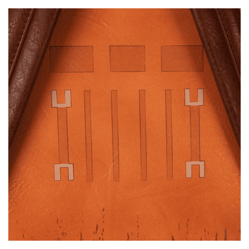 Close-up of an brown faux leather surface with embossed patterns, possibly from a bag or wallet.