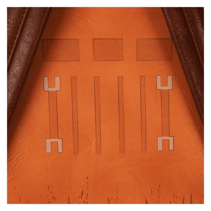 Close-up of an brown faux leather surface with embossed patterns, possibly from a bag or wallet.