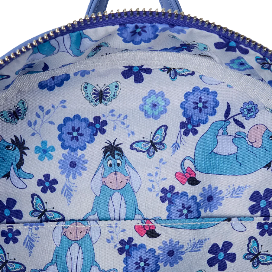 Backpack with Eeyore  design featuring blue flowers and butterflies.
