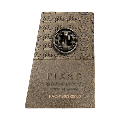 Pin with Pixar logo on a textured brown background