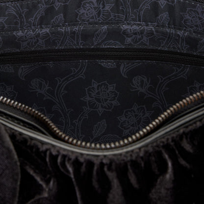 Close-up of a black textured fabric with floral patterns and a zipper.