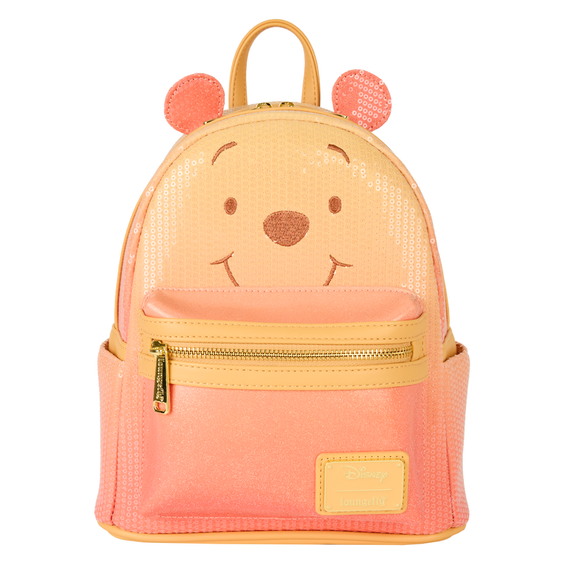 Orange Winnie the Pooh Loungefly backpack with bear face design on a white background