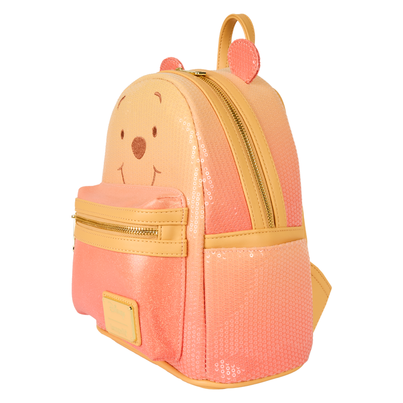 Orange and yellow Winnie the Pooh Loungefly backpack with bear face design on a white background