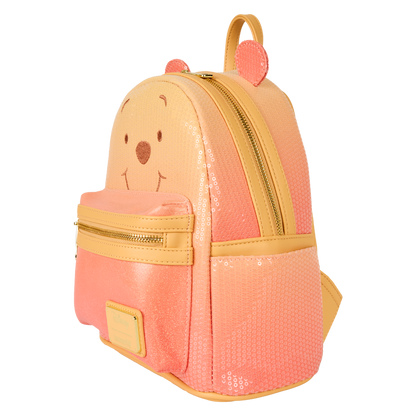Orange and yellow Winnie the Pooh Loungefly backpack with bear face design on a white background