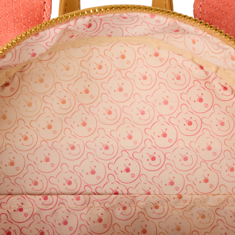 Close-up of a Winnie the Pooh Loungefly  bag with Winnie pattern