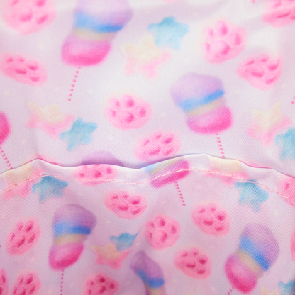 Judy Zootopia 2 interior lining fabric with colorful paw prints and cotton candy shapes on a pink background