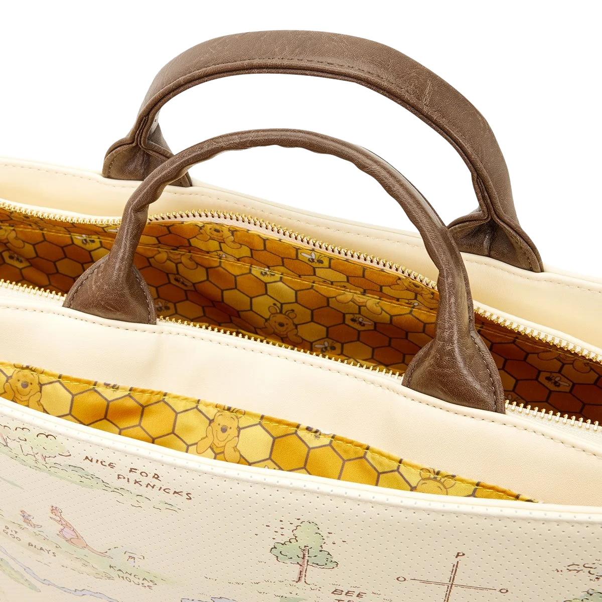 Close-up of a beige handbag with brown handles on a white background