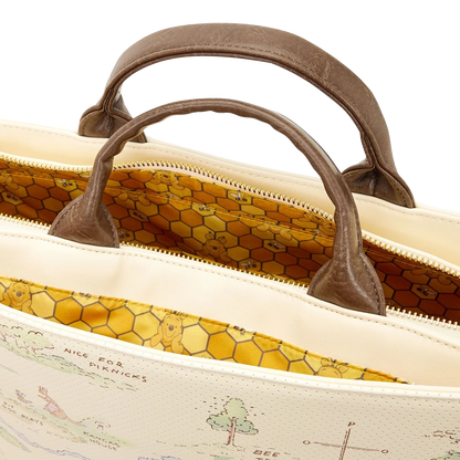 Close-up of a beige handbag with brown handles on a white background